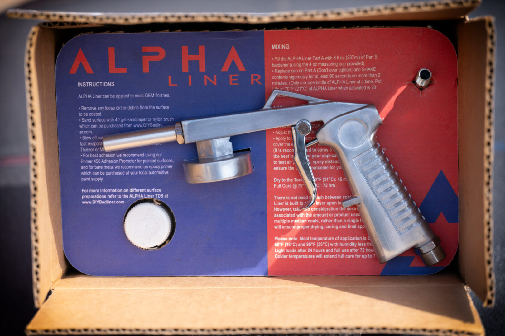 A gun sitting in the middle of a box.